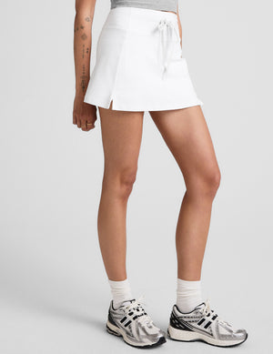 white mini skirt with a drawstring at waistband and built in shorts with pockets. 