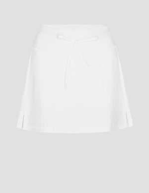 white mini skirt with a drawstring at waistband and built in shorts with pockets. 