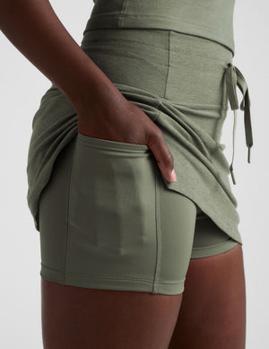 green mini skirt with a drawstring at waistband and pockets. 