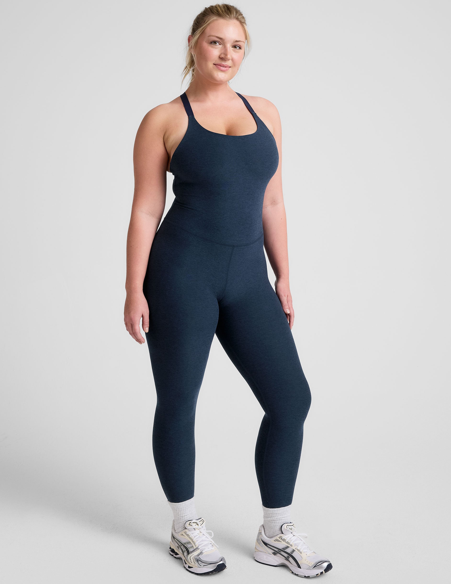 blue midi length jumpsuit with cross straps on back. 