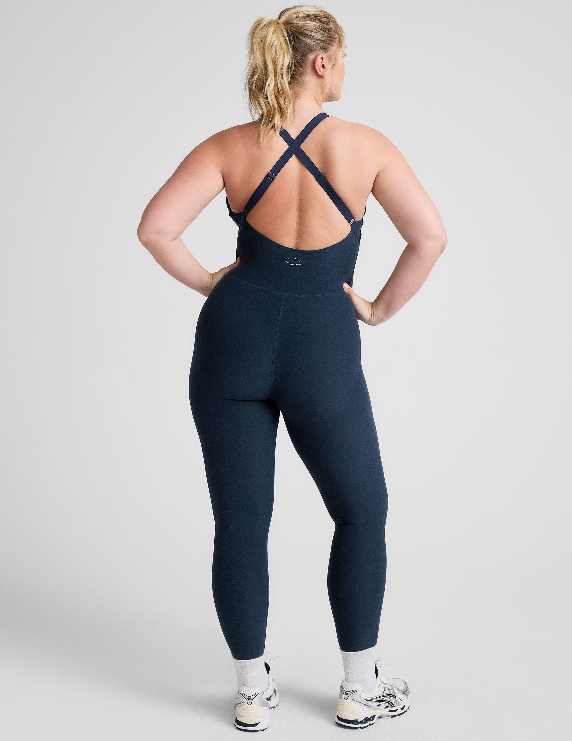blue midi length jumpsuit with cross straps on back. 