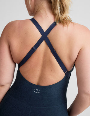 blue midi length jumpsuit with cross straps on back. 