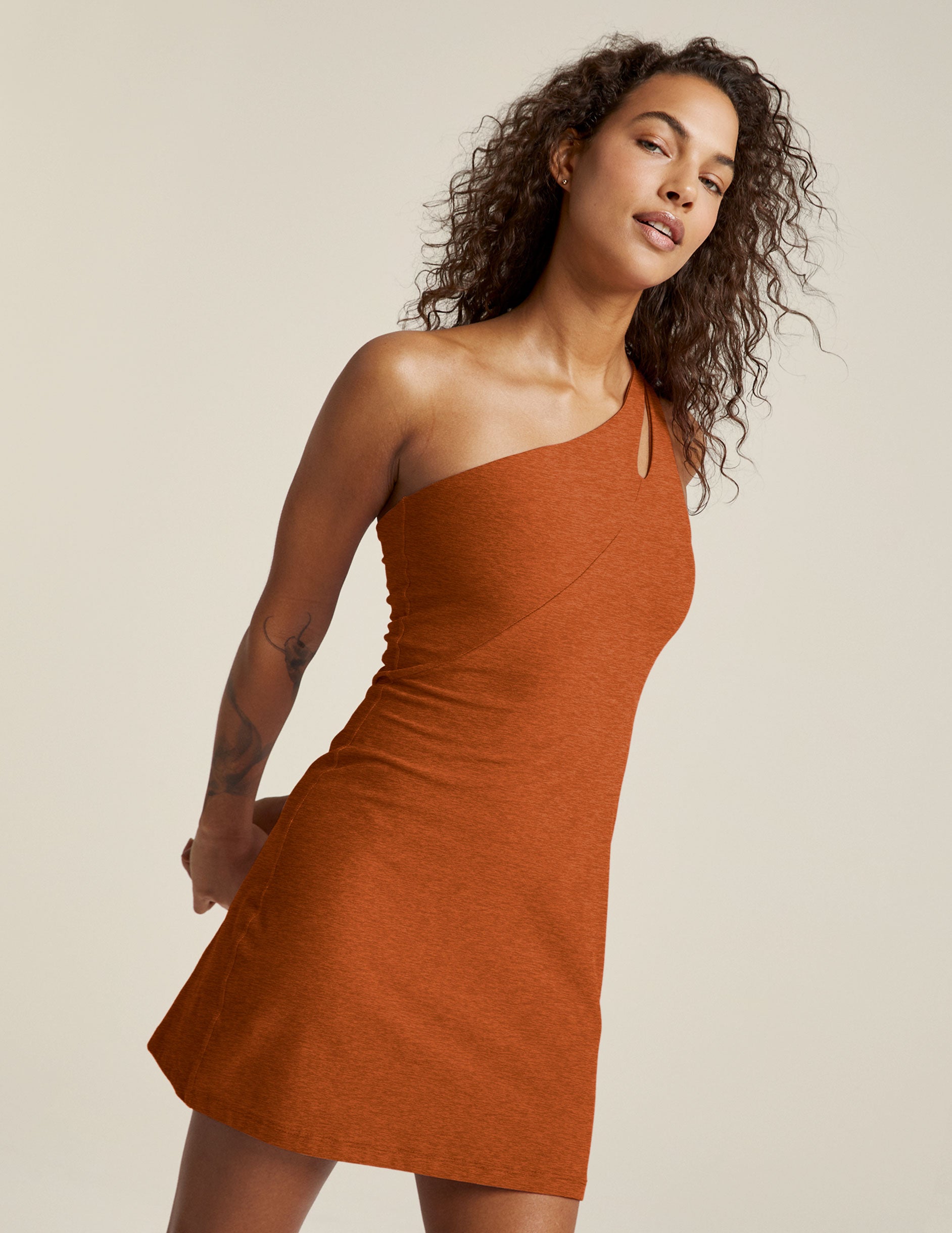 brown one-shoulder mini dress with a cutout detail on the strap. 