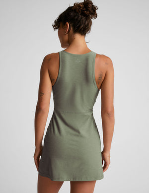 green mini active dress with a zipper on the front neckline and a side slit. 