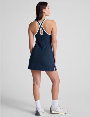 navy blue mini length dress with a front V neckline​, back keyhole detail​, contrast binding at neckline and arm openings, and an Interior bodysuit with pockets​. 