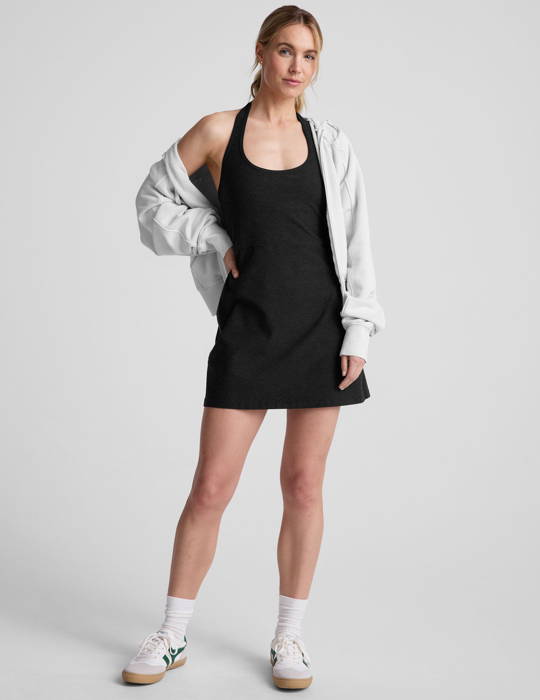 black mini style dress with an over the neck halter strap and a built-in bodysuit with pockets. 
