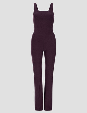 purple square neck bootcut jumpsuit on a light gray background. 