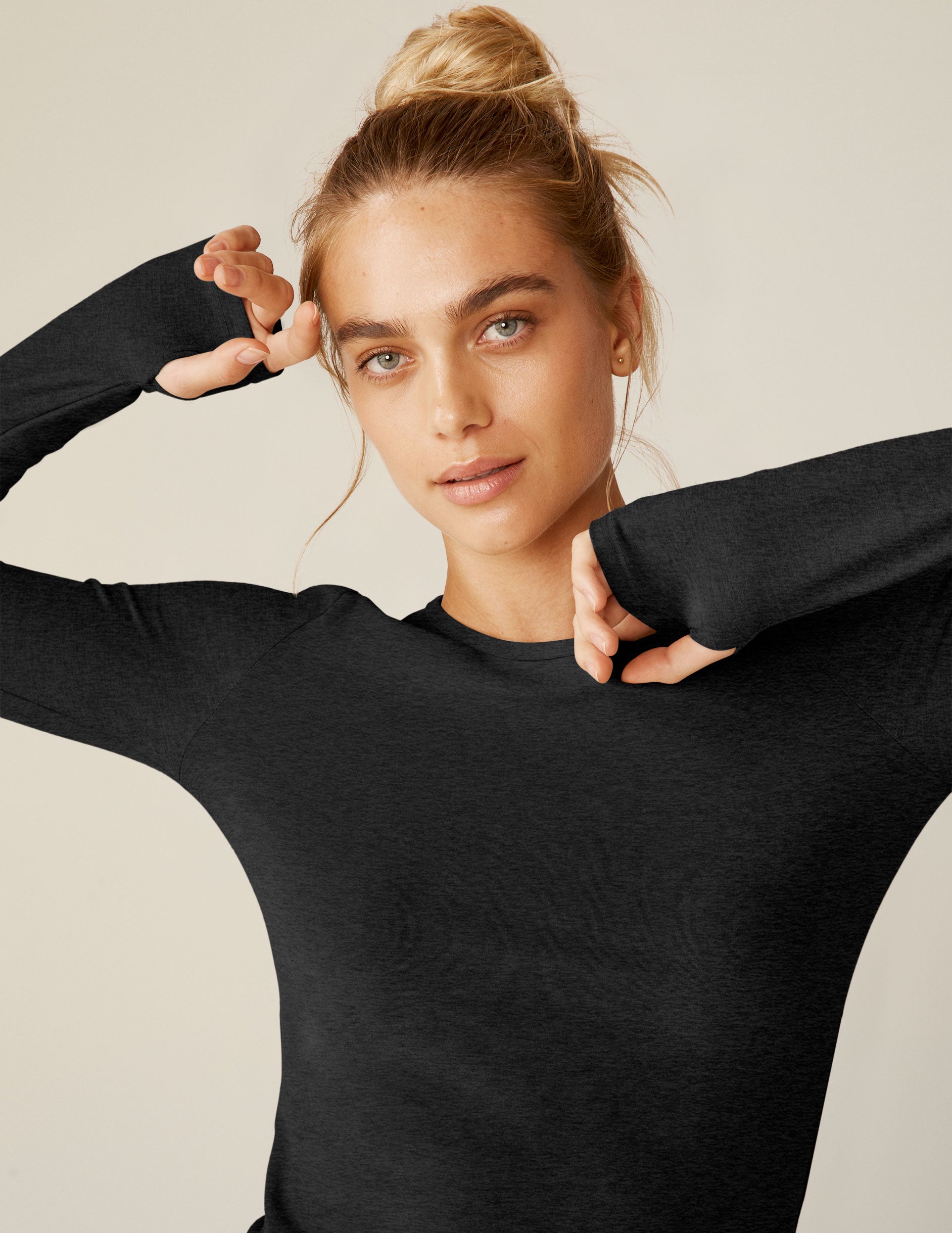 black long sleeve pullover top with thumb holes. 