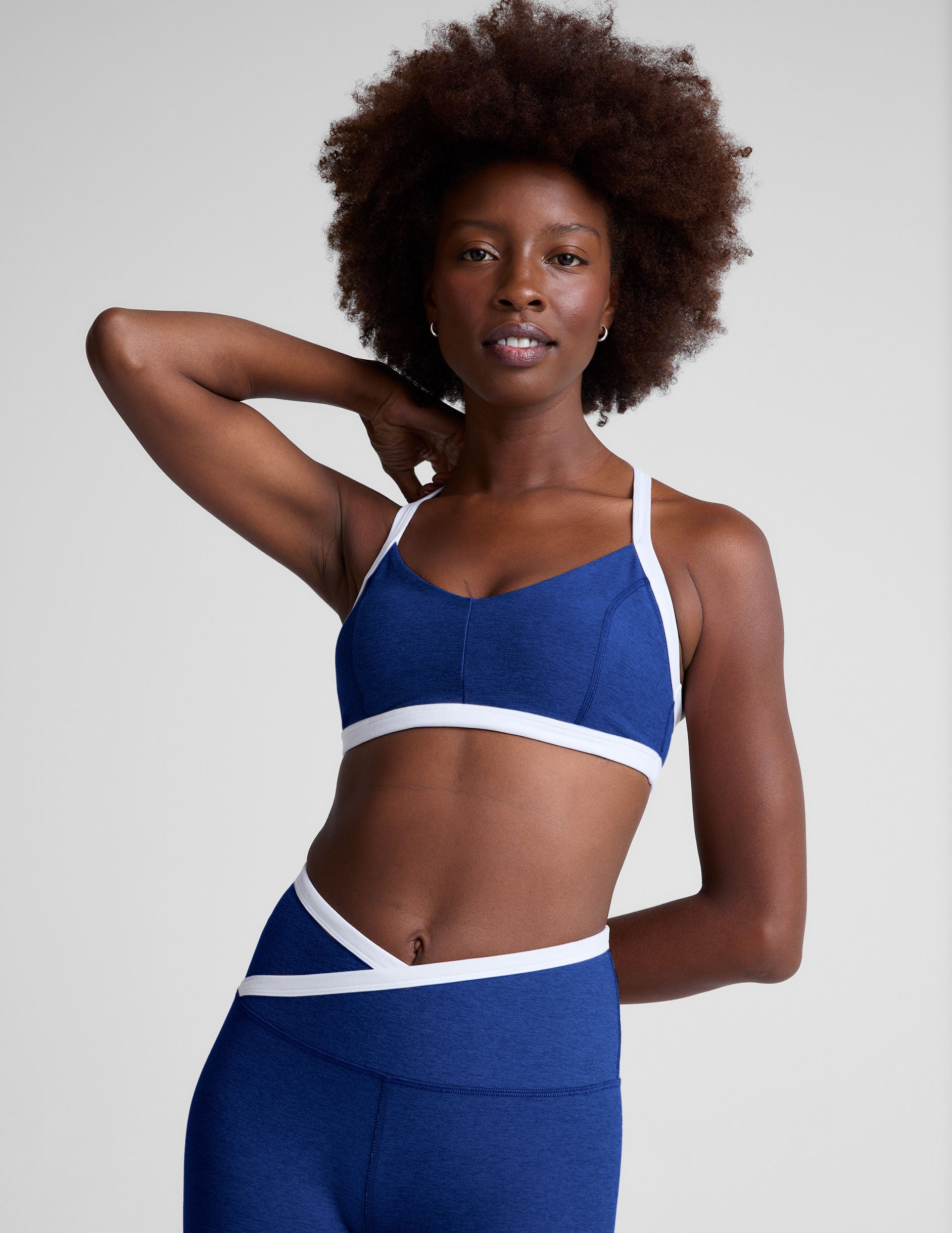 blue medium support, self-lined, v-neck with princess seams bra with white contrast binding at straps and hemband.