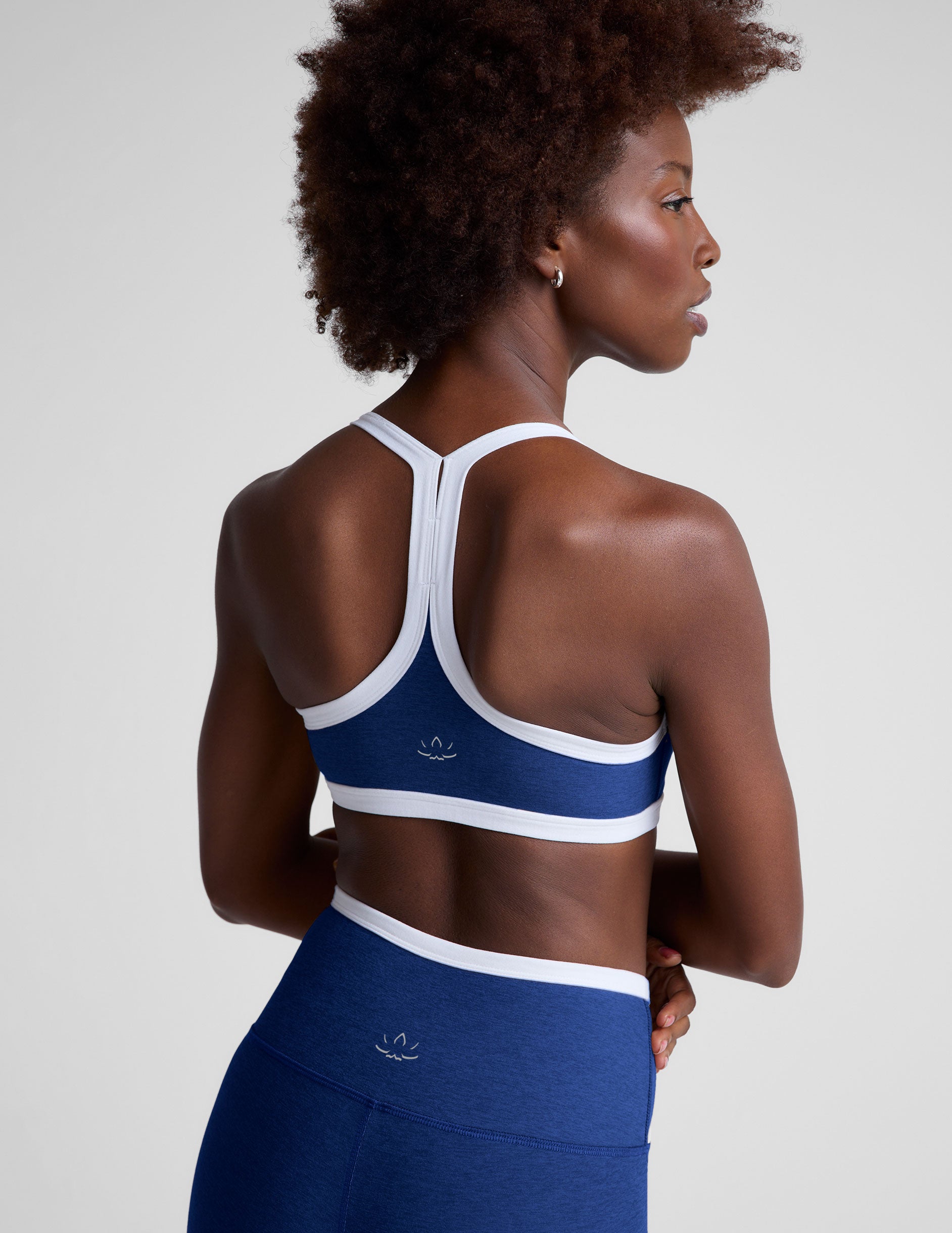 blue medium support, self-lined, v-neck with princess seams bra with white contrast binding at straps and hemband.