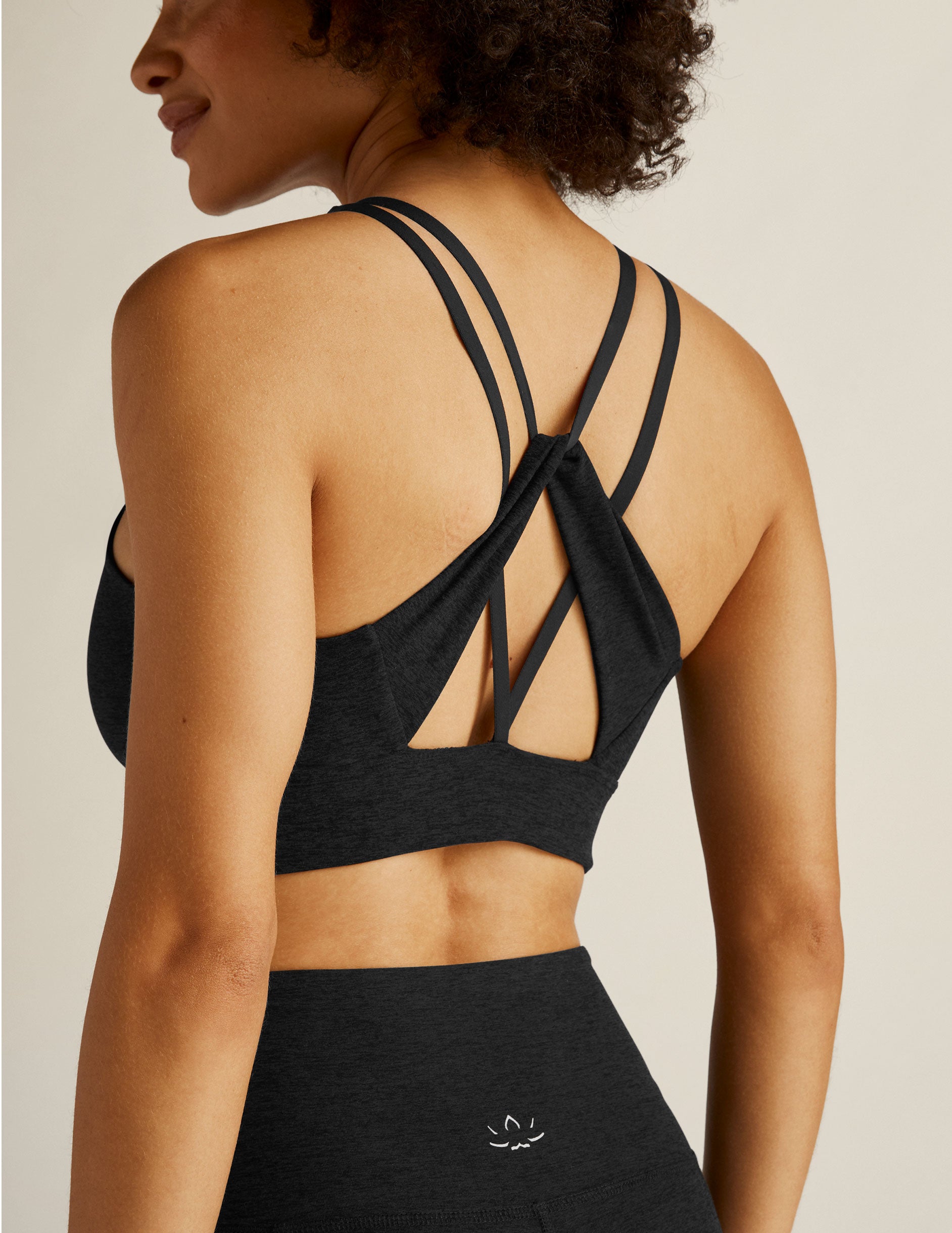 black bra top with an open back, strap detail.
