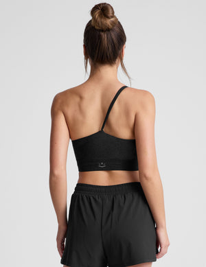 black long line length bra with a one strap detail and open back. 