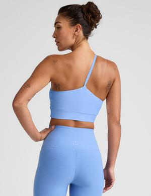 blue long line length bra with a one strap detail and an open back. 