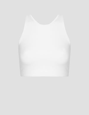 white high-neck racerback sports bra on a light gray background. 