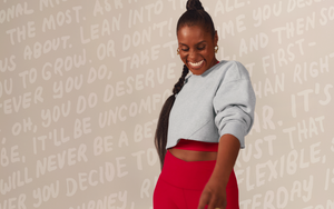 issa rae wearing gray sweatshirt and red high-waisted leggings against a light background with text. 