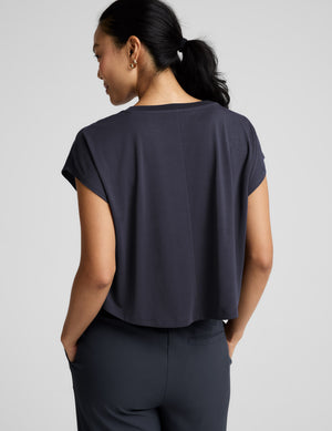 Woman wearing a blue shorts and trousers on a plain background. 