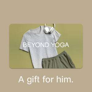 Gray t-shirt, green pants, and white headphones on a green mat with 'BEYOND YOGA' text.