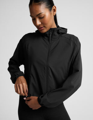 Person wearing a black jacket on a light gray background. 