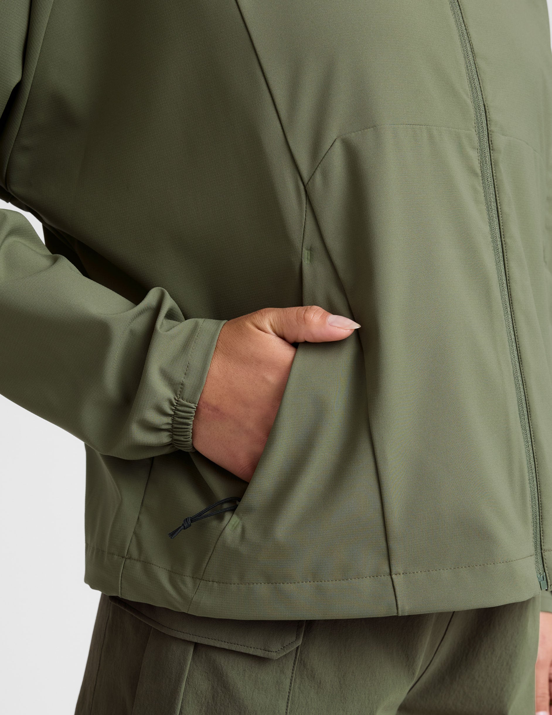 green zip-up jacket with a hood and pockets. 