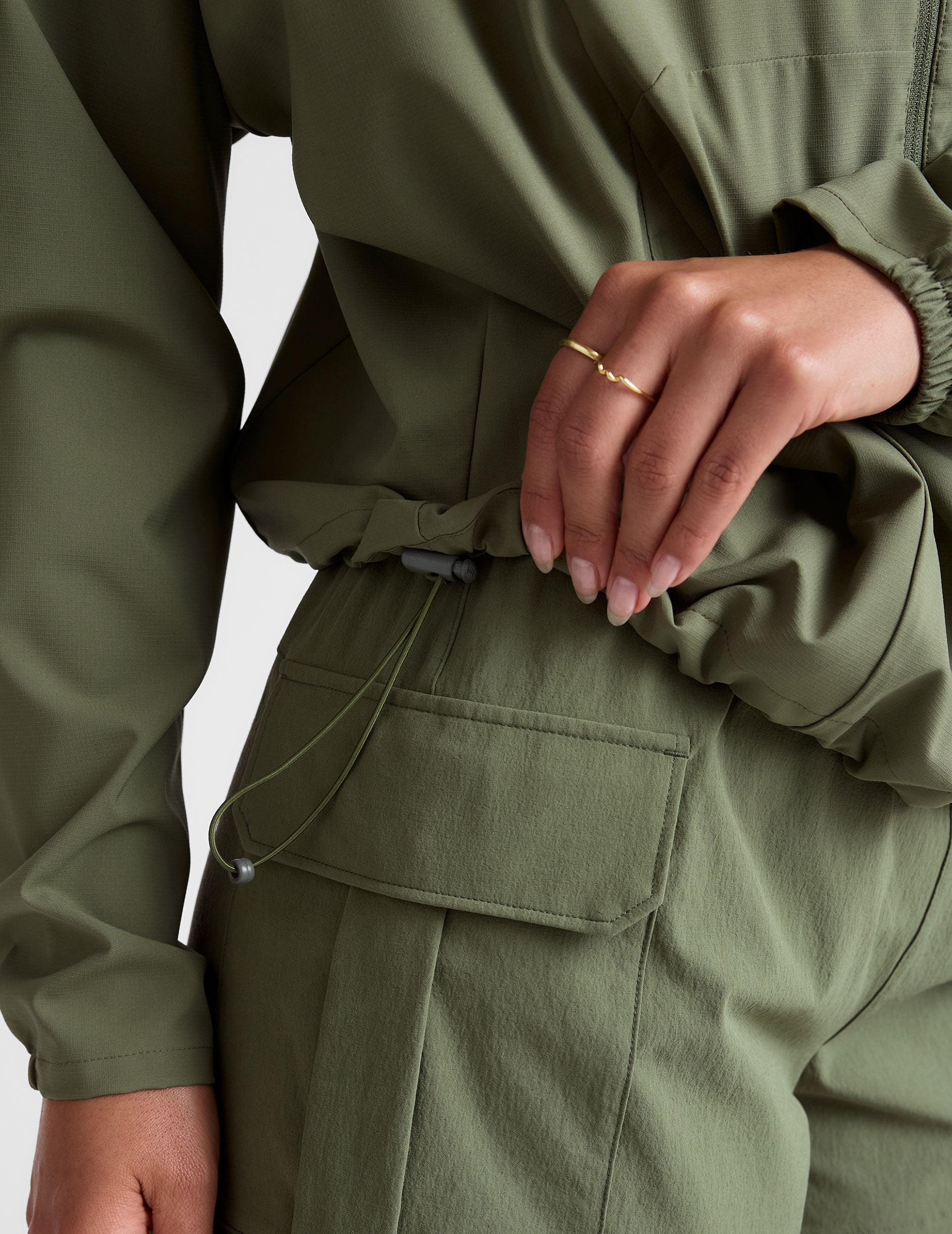 green zip-up jacket with a hood and pockets. 
