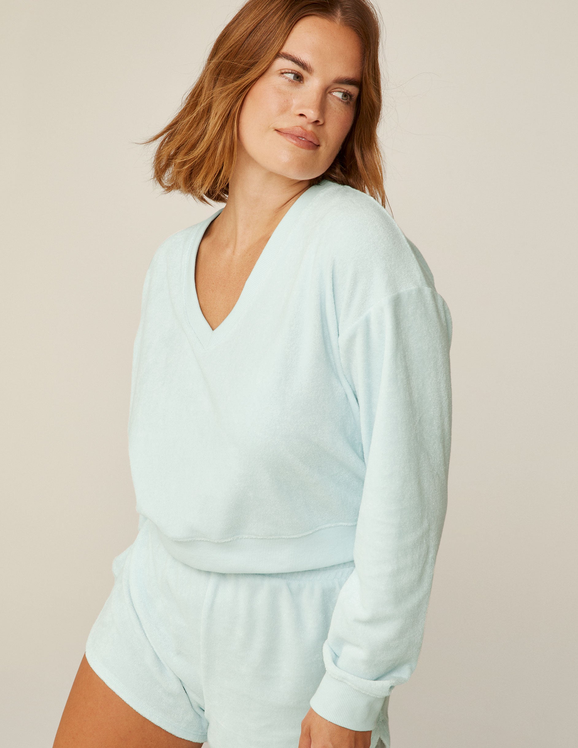 blue v-neck terry fabric long sleeve pullover. 