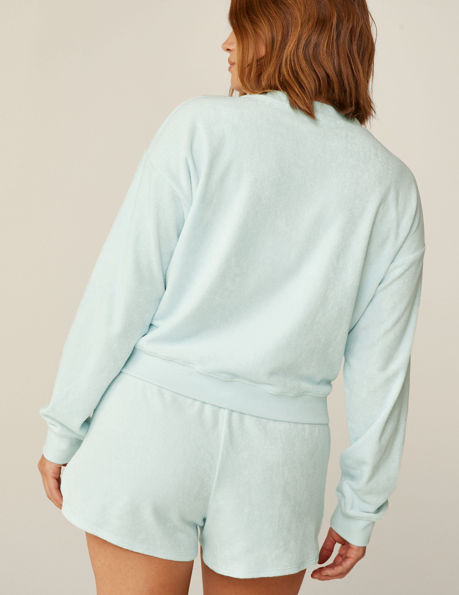 blue v-neck terry fabric long sleeve pullover. 