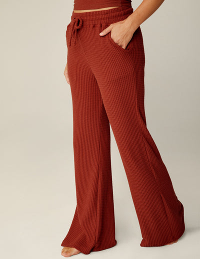 red waffle knit pants with a drawstring at waistband. 