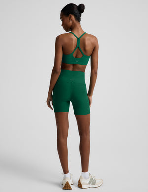 Woman wearing a green racerback bra and 5