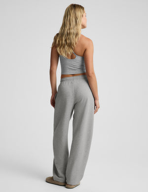 A woman shown from the back wearing a light gray two-piece lounge set consisting of a cropped tank top and matching wide-leg sweatpants, against a light gray studio background.