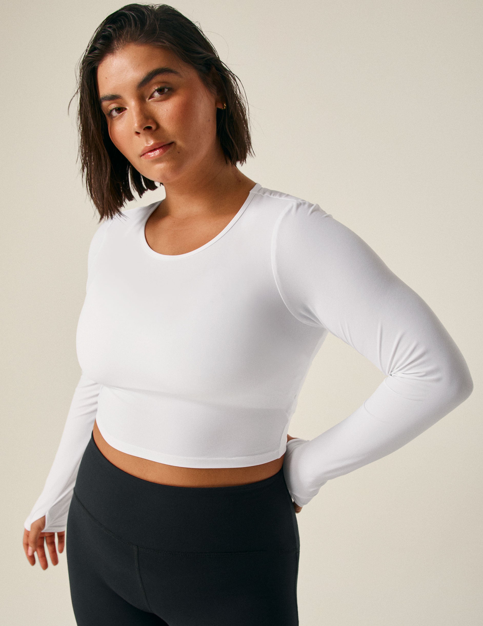 white long sleeve cropped top with an open back detail.