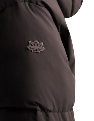 Close-up of a dark brown puffer jacket showing the textured fabric and a small tonal embroidered lotus logo on the upper chest, set against a plain white background.