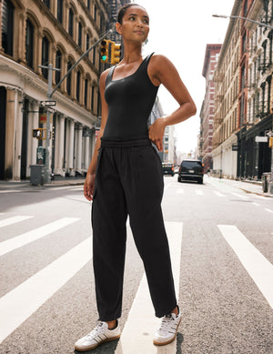 Woman wearing Java Peak Pant™ paired with a black tank top and white sneakers, featuring side zipper cargo pockets.