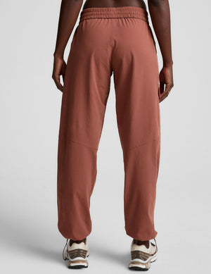 Rear view of the brown Peak Pant showing the elastic waistband, relaxed fit, and cinched bungee hems at the ankles.