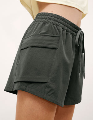 Green shorts with a drawstring on a white background. 