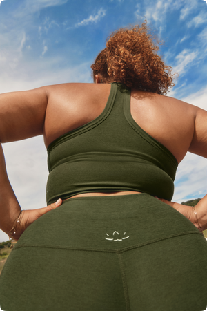 Danielle Burnett wearing an Army Green Spacedye crop tank and matching pair of leggings.