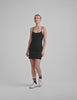 black mini dress with slim adjustable straps and built-in shorts with pockets.