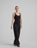 black ribbed tank top with a soft V neckline front and back​, overlapping front neckline detail, and a performance lining shelf bra. Tank hits at a high hip length. 
