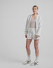 white zip-up jacket with hoodie and pockets. 