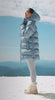 video of a girl in a blue long length puffer jacket, girl in a red set, man and woman jumping off a rock, and lastly a girl in a quilted jacket and matching set. 