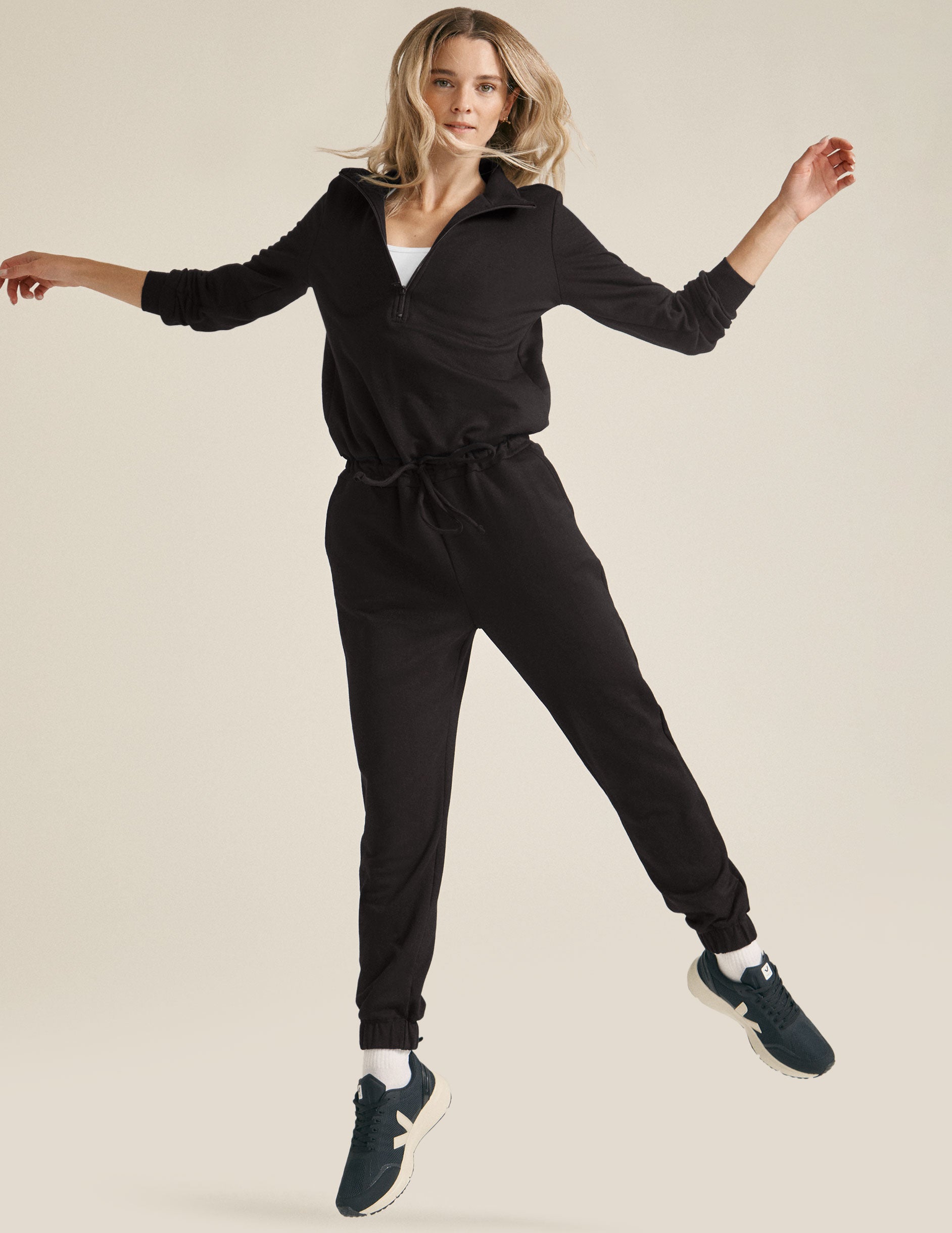 black half zip knit jumpsuit with drawstring at waist