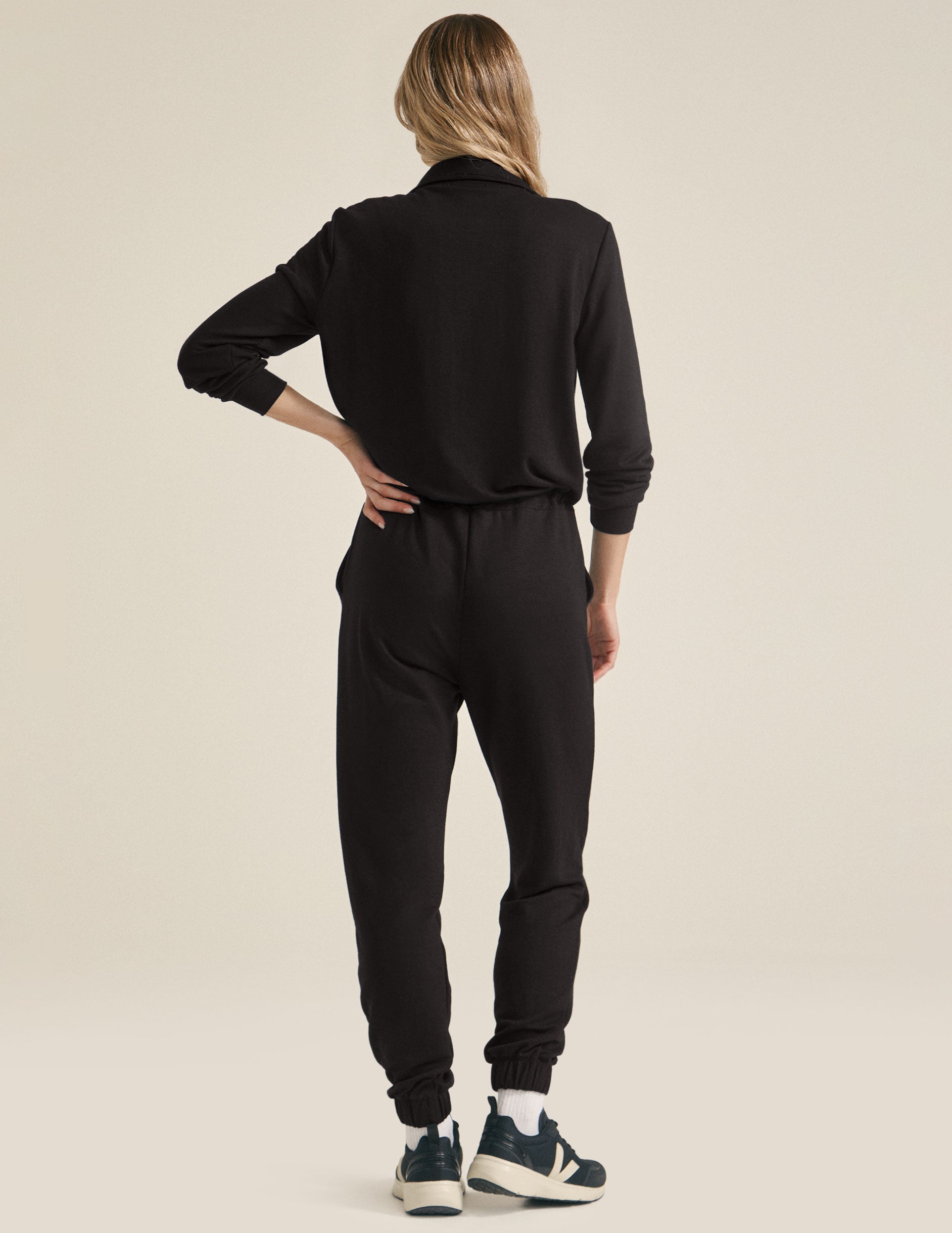 black half zip knit jumpsuit with drawstring at waist