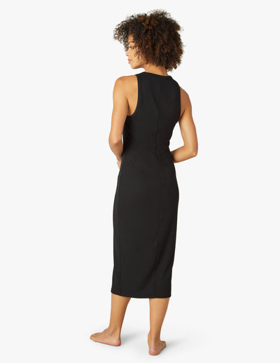 black sleeveless midi slim fitting dress with a side slit at right leg