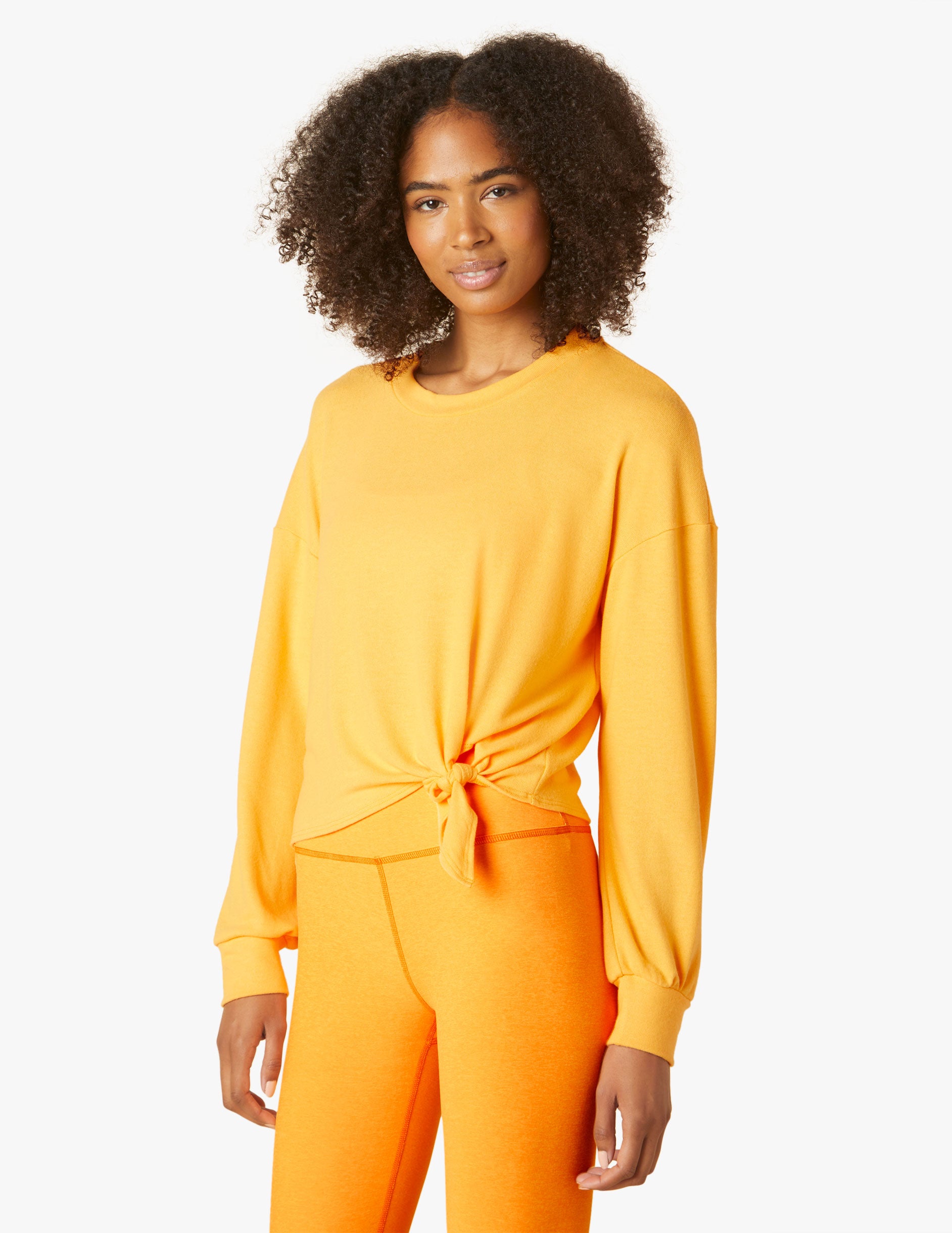 orange long sleeve pullover with tie front at waist