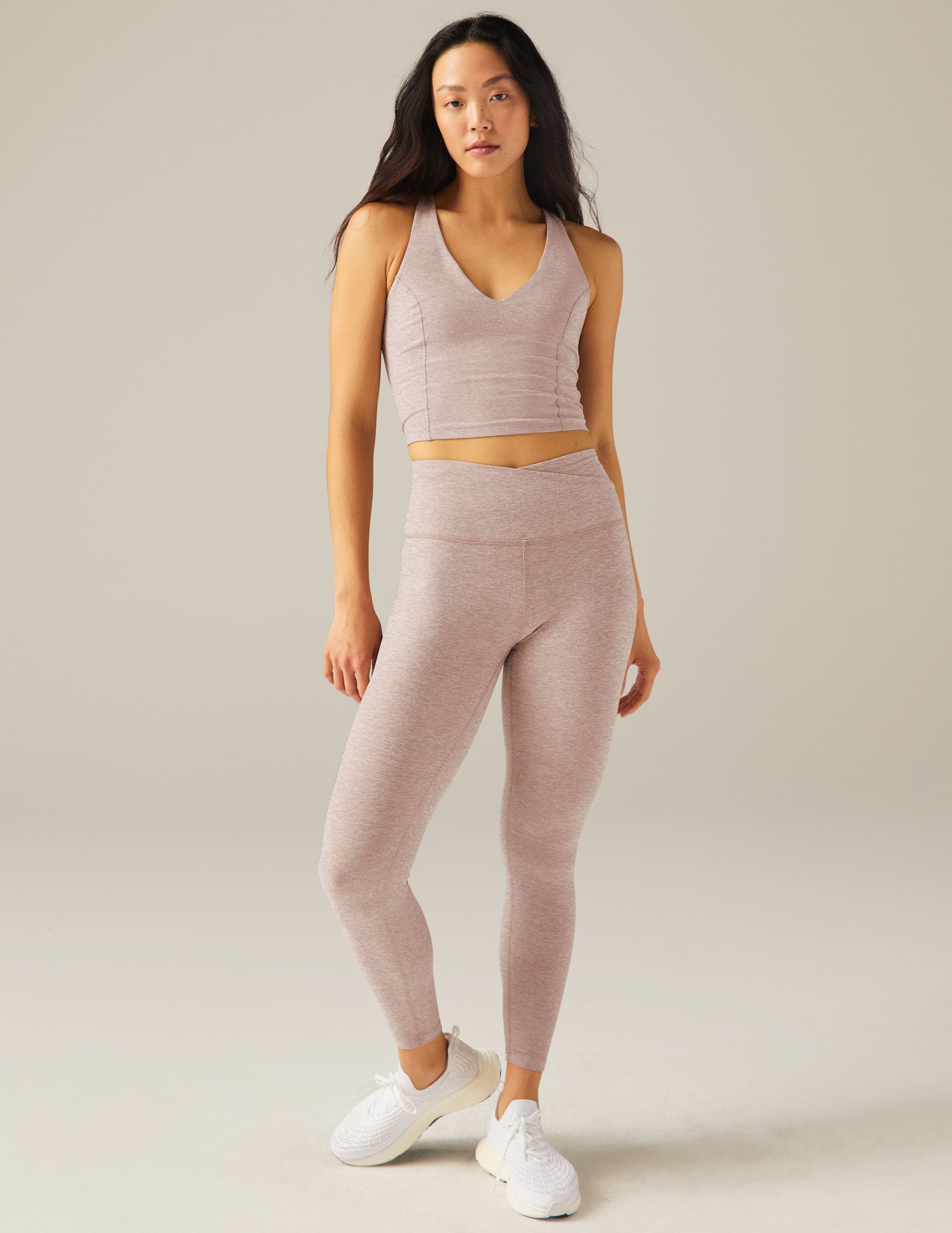 pink crop top with open back paired with high waisted legging