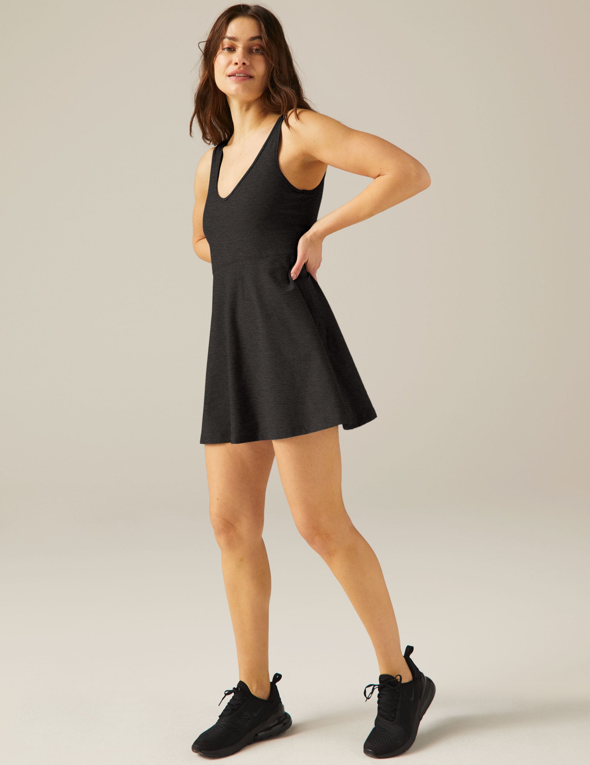 black flare mini dress with short pocket detail underneath